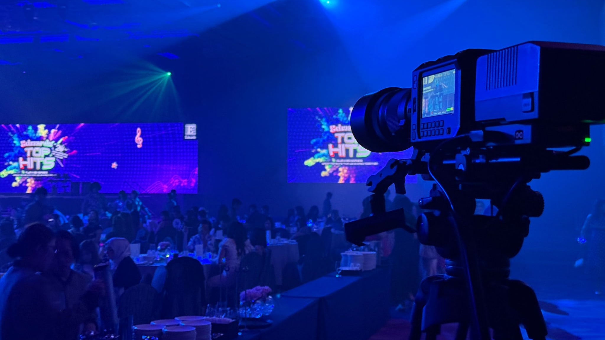 Broadcast camera covering a corporate gala dinner in a Singapore ballroom