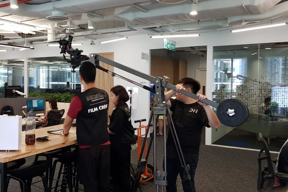 Dustin Hill crew filming with a jib in a client office